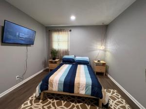 a bedroom with a bed and a flat screen tv at Cozy Rockford Home in Rockford