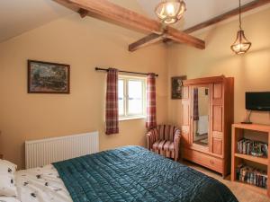a bedroom with a bed and a window and a chair at The Flo Jo in Ellesmere