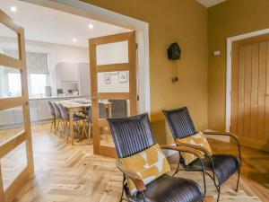 a living room with chairs and a dining room at The Wheatley in Ilkley