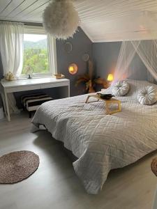 a bedroom with a large bed and a window at Hytte Sørlandet med spa in Froland Verk