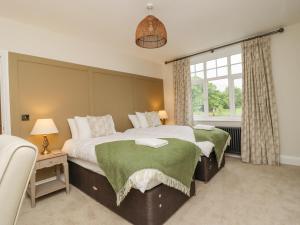 a bedroom with two beds and a window at The Wheatley in Ilkley