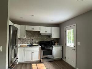 a kitchen with white cabinets and a stove at Cozy Rockford Home in Rockford