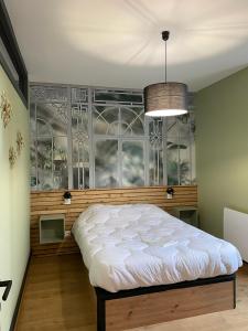 a bedroom with a bed in front of a window at Chez Enzo in La Bourboule