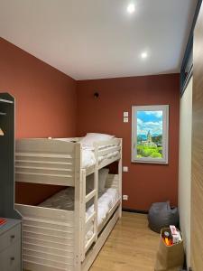 a bedroom with two bunk beds in a room at Chez Enzo in La Bourboule