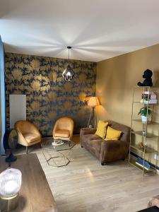 a living room with a couch and a chair at Chez Enzo in La Bourboule