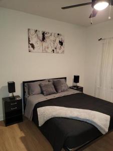 a bedroom with a large bed with two night stands at South Charlotte’s Cozy & Modern in Charlotte