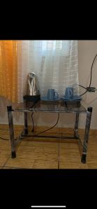 a glass table with a tea pot and cups on it at Hotel y Balneario Villa Paraíso in Catacamas