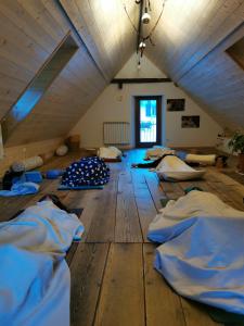 an attic room with many pillows on the floor at Sentiero Verde B&B in Formazza