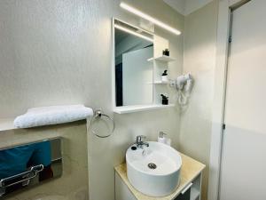 a bathroom with a sink and a mirror at CCD Seaview Apartments in Năvodari