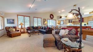 a large living room with couches and a table at Snowcreek V #757 condo in Mammoth Lakes