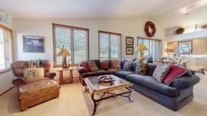 a living room with two couches and a table at Snowcreek V #757 condo in Mammoth Lakes