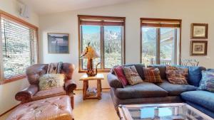 a living room with two couches and a table at Snowcreek V #757 condo in Mammoth Lakes +79 photos