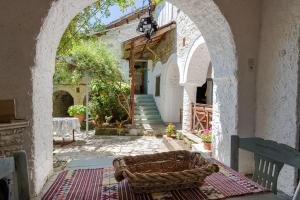 an archway in a building with a basket on a rug at Monodendri Vintage House in Monodendri