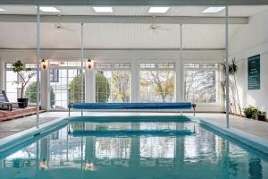 a large swimming pool with blue water in a building at Evangeline in Grand pré