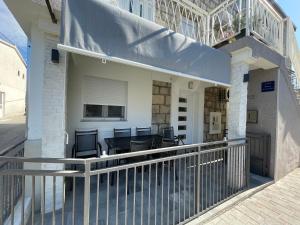 a balcony of a house with a table and chairs at Da Da in Kaštela