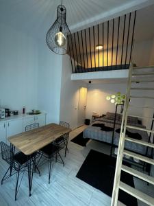 a bedroom with a loft bed and a table and chairs at Vila Ana Boutique Hotel in Cluj-Napoca