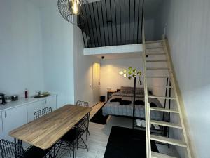 Pokój z łóżkiem na podwyższeniu i drewnianym stołem w obiekcie Vila Ana 2 Untold w Klużu-Napoce
