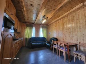 - une cuisine et une salle à manger avec une table et un canapé dans l'établissement Peak House, à Kazbegi