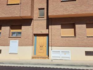 un edificio de ladrillo con una puerta y ventanas marrones en Apartamento Torre Sancho, en Valderrobres