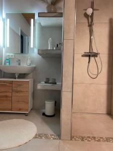 a bathroom with a shower and a sink at Marina Beach Lauenburg in Lauenburg