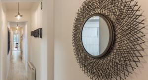 a mirror hanging on a wall in a hallway at Apart Infante Casco Histórico de Ribadesella VUT-1322-AS in Ribadesella