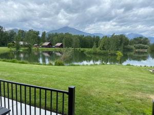 a view of a lake with houses and a fence at SkyWater Cabins in Hamilton