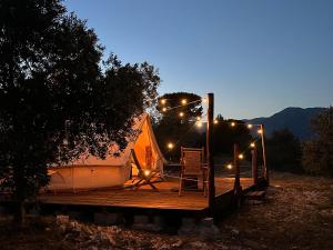 a tent with lights on top of a wooden deck at Il Favogoloso in Alatri