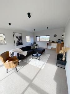 a living room with a couch and a table at Springvale Apartment in Alexandra