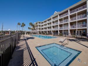 a swimming pool in front of a hotel at Grand Caribbean in Perdido Key 111E by Vacation Homes Collection in Pensacola