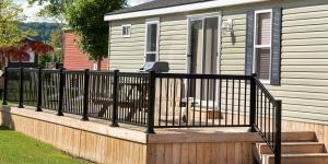 a dog sitting on a deck with a fence at Vine Ridge Resort in Niagara on the Lake