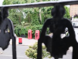 a view of three red phone booths from a window at Fabulous Stay in Primrose Hill in London