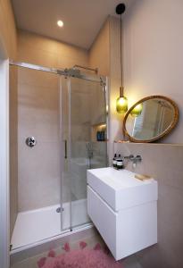 a bathroom with a shower and a sink and a mirror at Fabulous Stay in Primrose Hill in London