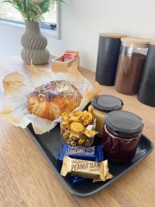 a tray of food with a pastry and peanut butter and jelly at Springvale Apartment in Alexandra