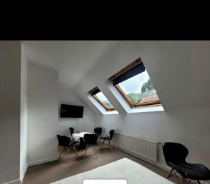 a room with a table and chairs and a window at Willa Aqua -parking included in the price in Świnoujście