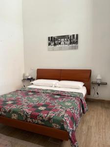 a bedroom with a bed with a quilt on it at B&B Il Panorama in Torre Maggiore