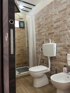 a bathroom with a toilet and a sink and a shower at B&B Il Panorama in Torre Maggiore +22 photos