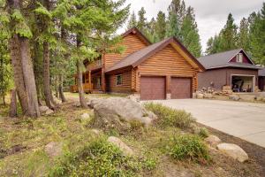 una casa de madera con entrada y garaje en Exquisite McCall Log Cabin - Walk to Payette Lake!, en McCall