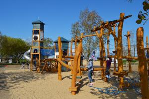 a group of people standing in a playground at Évasion en Bord de Mer Maison Tout Confort à La Faute-sur-Mer in La Faute-sur-Mer