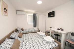 Ένα ή περισσότερα κρεβάτια σε δωμάτιο στο Olymp Apartmani