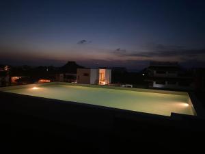 a view of a swimming pool at night at Sunsteps suite pyramids in Holbox Island