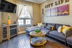 a living room with a couch and a tv at Cozy Philadelphia Rental Steps to Subway Station! in Philadelphia