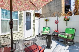 a patio with a table and chairs and an umbrella at Cozy Philadelphia Rental Steps to Subway Station! in Philadelphia