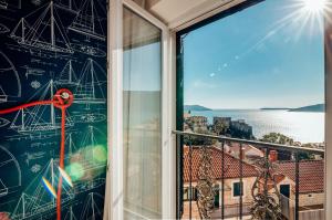 a window with a view of the water at Apartments Master 5 in Herceg-Novi