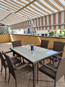 a table and chairs on a patio with an umbrella at riva vacanze in Riva Ligure