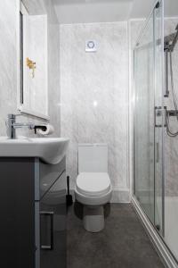 a bathroom with a toilet and a sink and a shower at Greenbourne - 4 bedrooms Sleeps 8 free parking in Gateshead