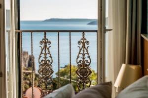 a room with a window with a view of the ocean at Apartments Master 5 in Herceg-Novi