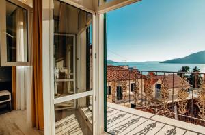 a balcony with a view of a building at Apartments Master 5 in Herceg-Novi