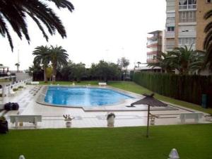 a large swimming pool in the middle of a park at Fantastic Seaview Apartment in Alicante