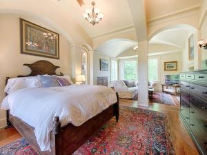 a bedroom with a large bed and a living room at Adams Hill House Retreat - Artist-Architect's Estate, Newfane Vermont in Newfane