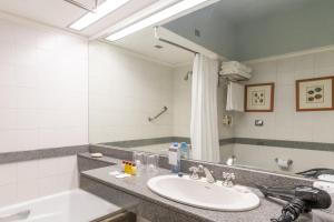 a bathroom with a sink and a mirror at Sheraton Mar Del Plata Hotel in Mar del Plata